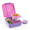 Omie Pink and purple bento lunchbox with compartments containing food on a white background
