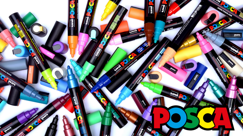 Assorted Posca markers in various colors on a white background
