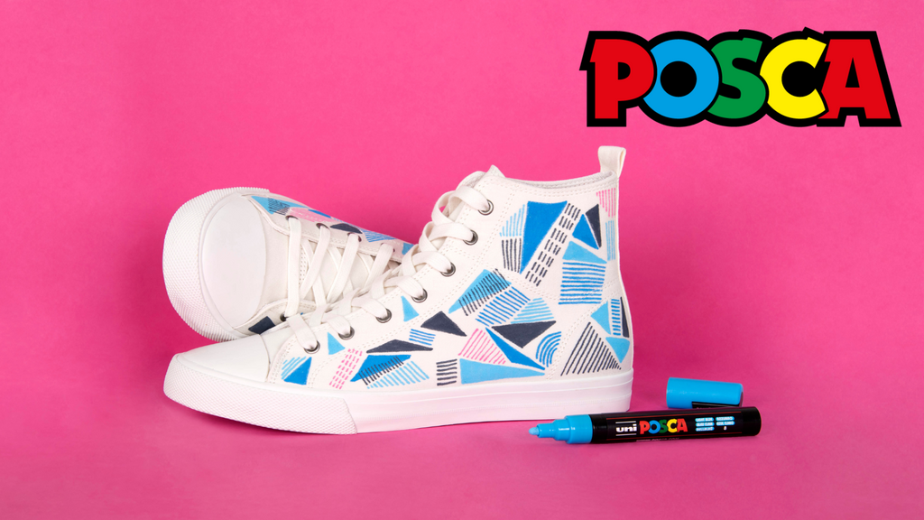 White high-top sneakers with geometric pattern and POSCA marker on pink background