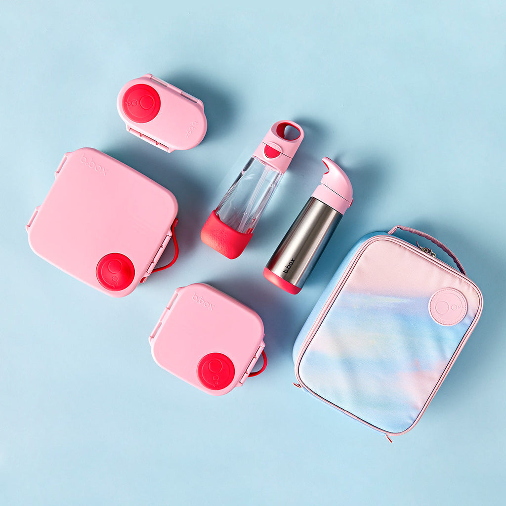 bbox flamingo fizz Pink and clear lunch box, water bottle, and thermos on a light blue background